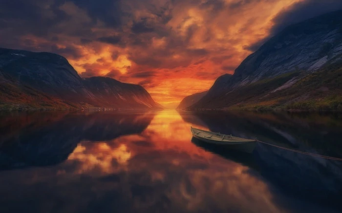 body of water summer sunset lake mountains boat reflection