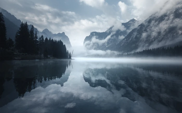 calm body of water nature landscape morning mist lake mountains