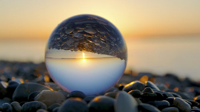 glass sphere water drops closeup stones marble beach reflection 2k
