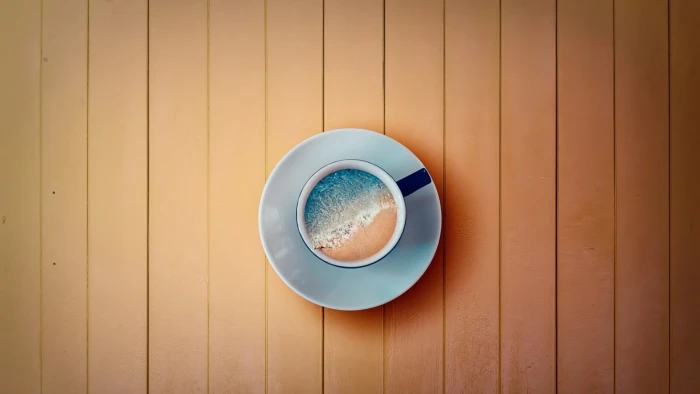 white and black ceramic mug digital art cup beach sea wooden surface 2k