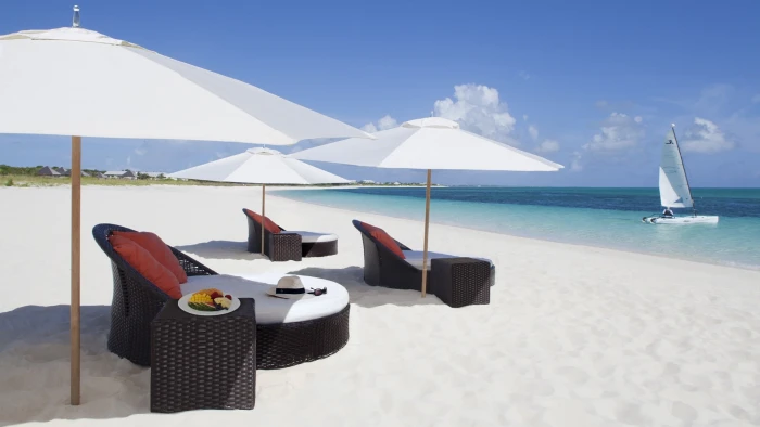white and black wooden table sand beach Caribbean tropical 2k