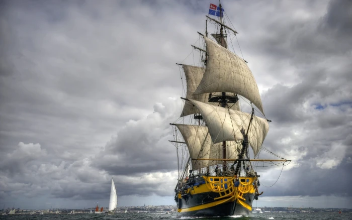 black and brown pirateship yellow ship sailing under cloudy sky 2k