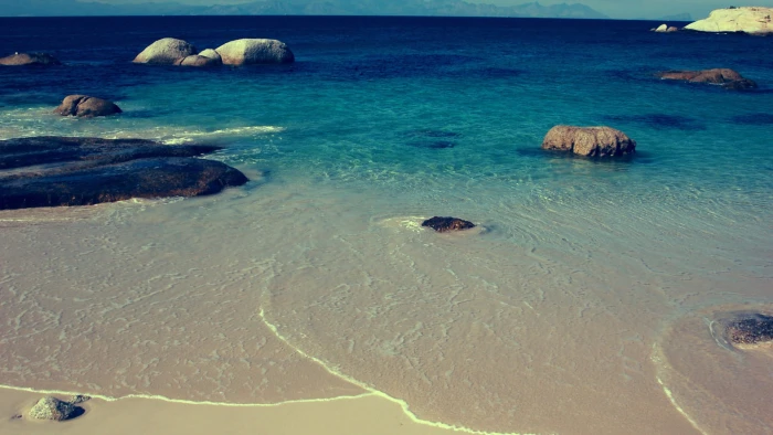 body of water beside white sand beach nature rock sea coast 2k