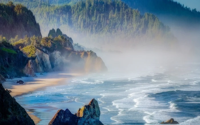body of water near mountain nature landscape mist beach sea 2k