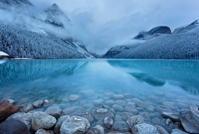 landscape photography of gray stone in body water during cloudy season 2k