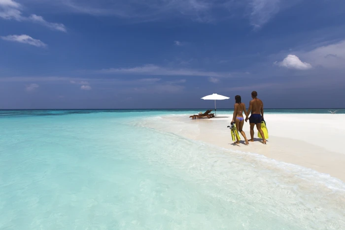 man and woman walking on white sand during daytime travel vacation 2k