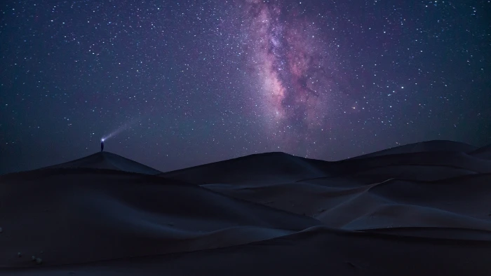 man standing on sand dunes at night digital wallpaper nature 2k