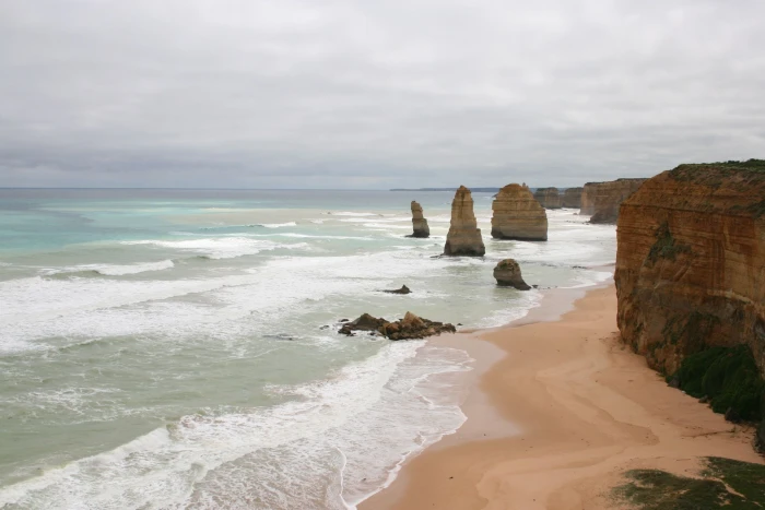 ocean waves hammering rock formation during daytime IMG australia 2k