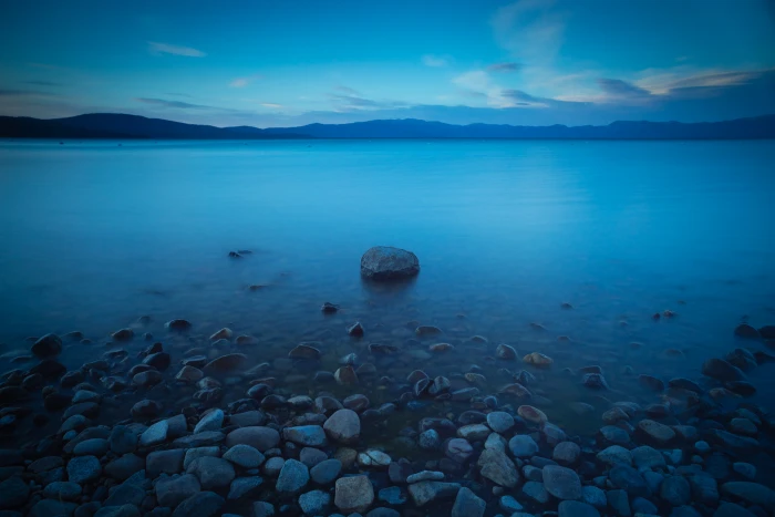 photo of rocks in sea shores lake tahoe sunset 2k
