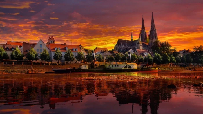 scenery of city building Regensburg sunset Donau river clouds 2k