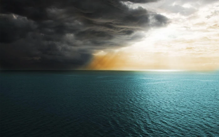 Storm clouds covering the sun body of water and dark 2k