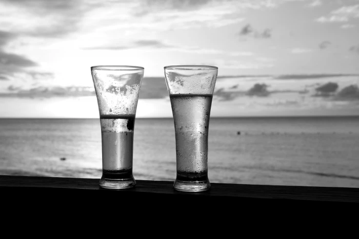 two clear glass candle holders glasses beach sky water food and drink 2k