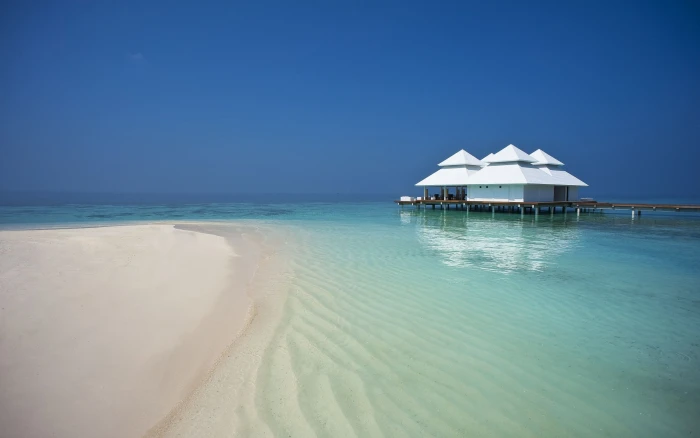 white and brown beach cottage waterfront Maldives nature sea 2k