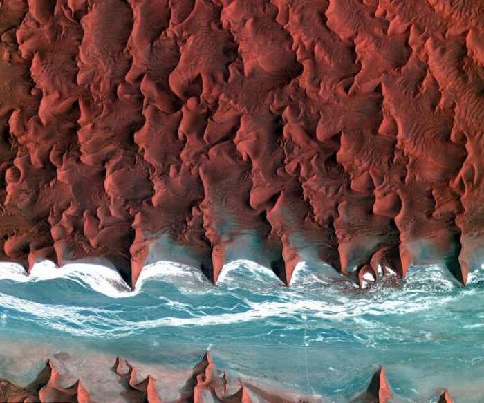 ocean waves on seashore during daytime Namibia desert coast