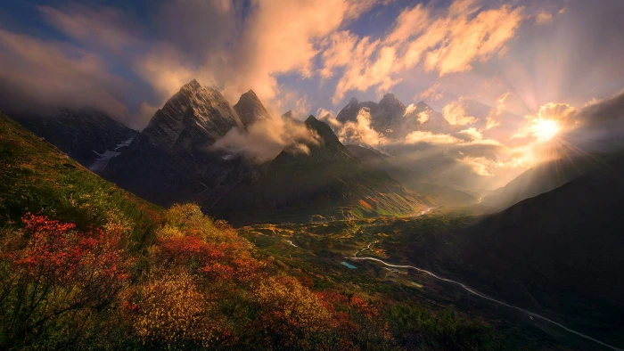 red and yellow petaled flowers mountain under cloudy sky during daytime 2k