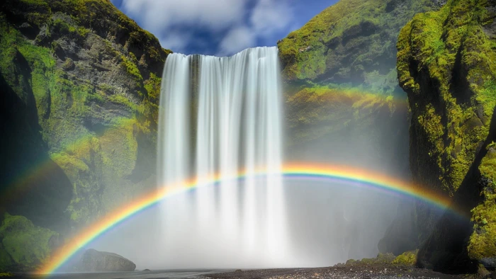 Skogafoss waterfalls between green trees nature 2k