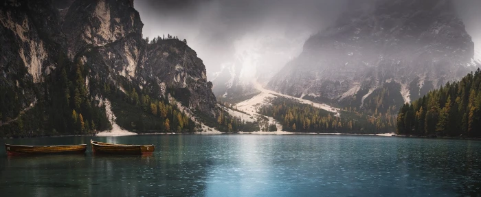 two brown row boats landscape photography of mountains beside body water 2k