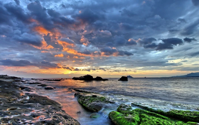 water sunset clouds sea rock landscape beach sky nature 2k