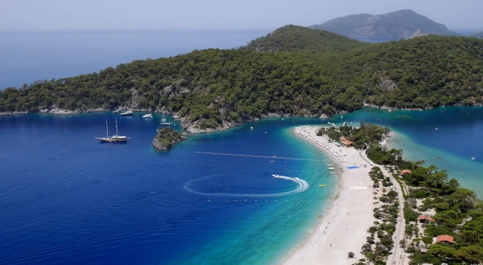 Blue Lagoon body of water and island surrounded by green leaf trees 2k