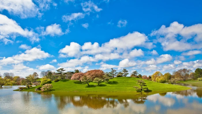 body of water near mountain under blue sky nature landscape 2k