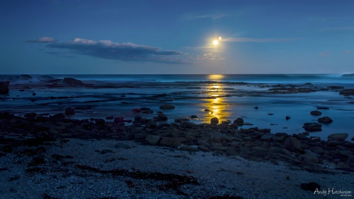 gray rocks beach sunset water sea sky scenics nature 2k