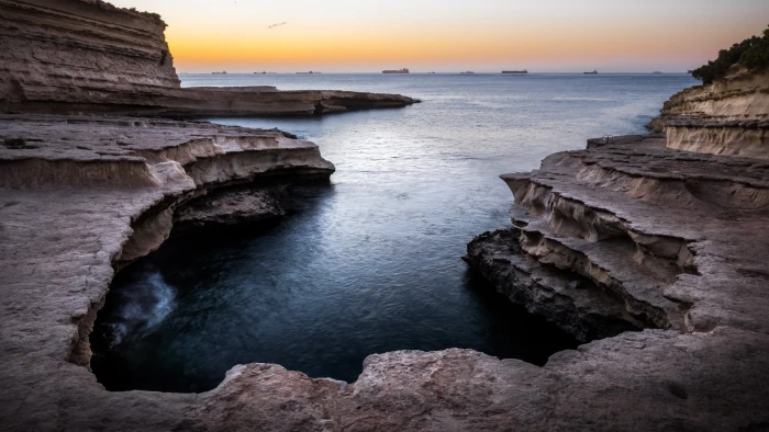 brown rock formation near body of water malta St Peter's pool 2k