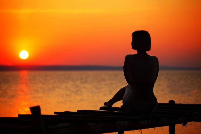 Silhouette of Woman Sitting on Dock during Sunset beach dawn 2k 4k 5k