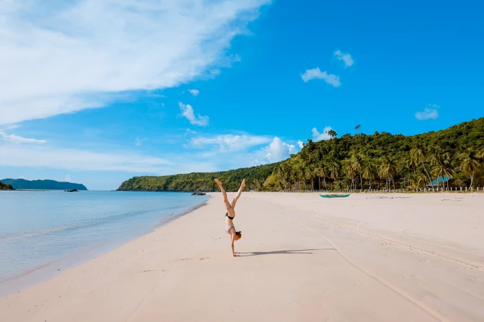 woman standing on hands beach sea ocean water waves nature 2k