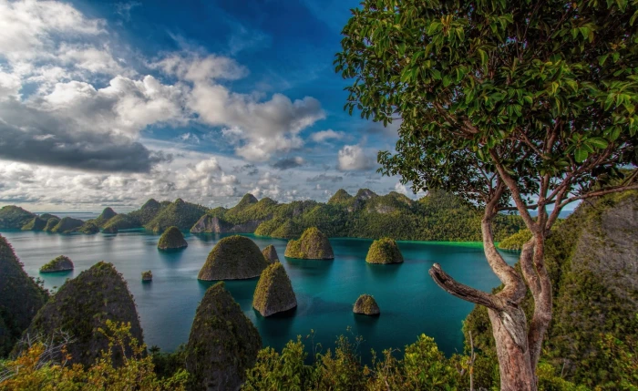 photo of islands during daytime mountains clouds forest tropical 2k