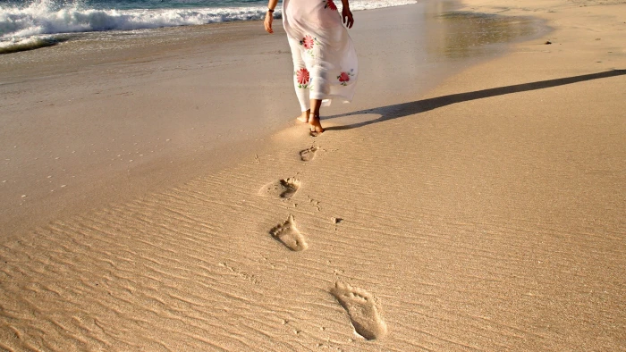 women s white and red floral skirt footprints beach sand shoreline 2k