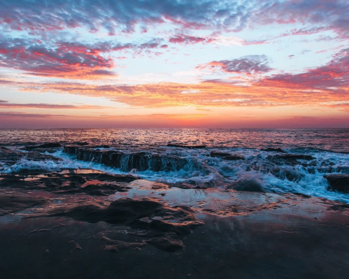 sea rock waves sunset beach clouds 2k