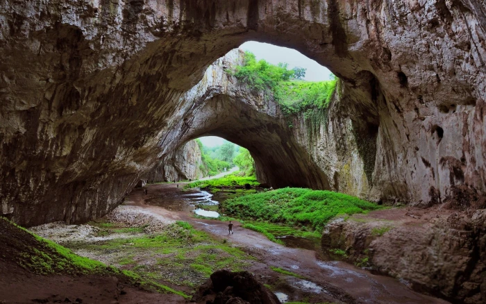 rock formation with mossy during daytime cave river grass 2k
