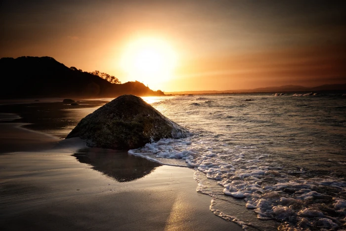 brown mountain beside ocean during sunset Day Fades golden 2k