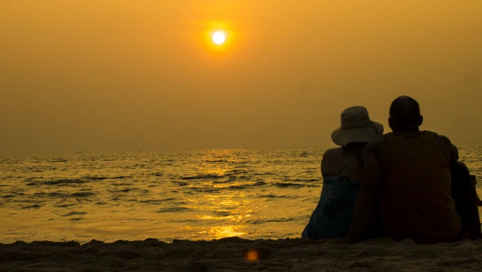 Man and woman sitting in beach side during dusk goa india 2k 4k