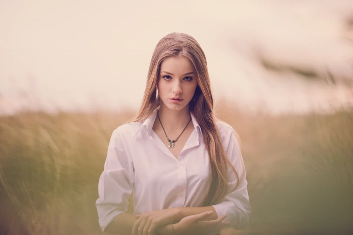 woman in white button up collared long sleeved shirt on grass field focus photography 2k 4k 5k