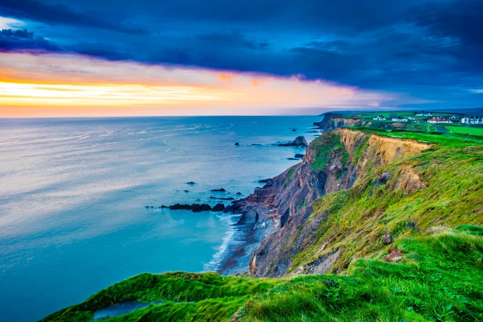 green grass cliff beside body of water bude united kingdom 2k