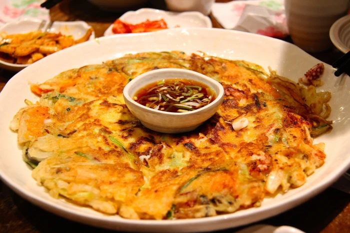 fried food with sauce on plate delicious korean kimchi pancake 2k