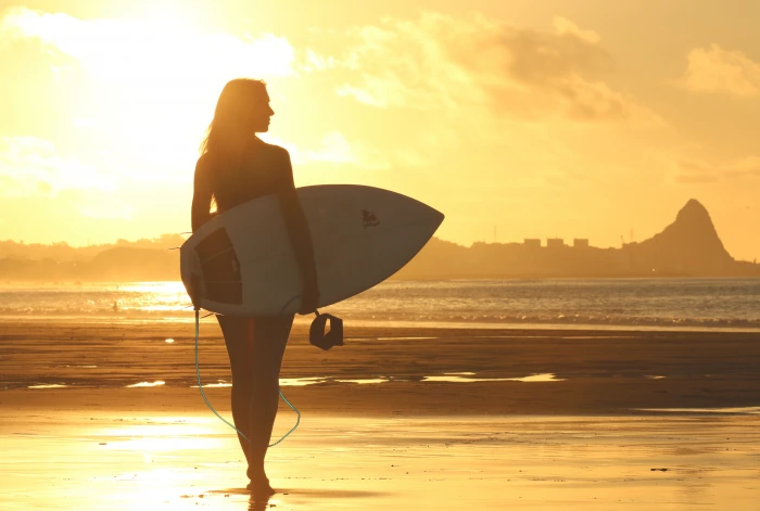 silhouette photography of woman holding surfboard beach clouds 2k 4k 5k