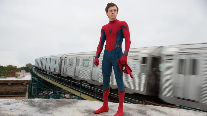 Spider Man standing near train during daytime man homecoming 2k 4k