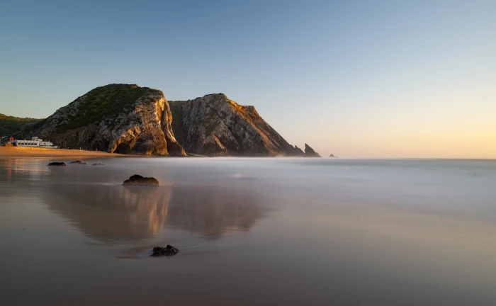 body of water near brown island Adraga Sunset Back Lit Beach 2k 4k