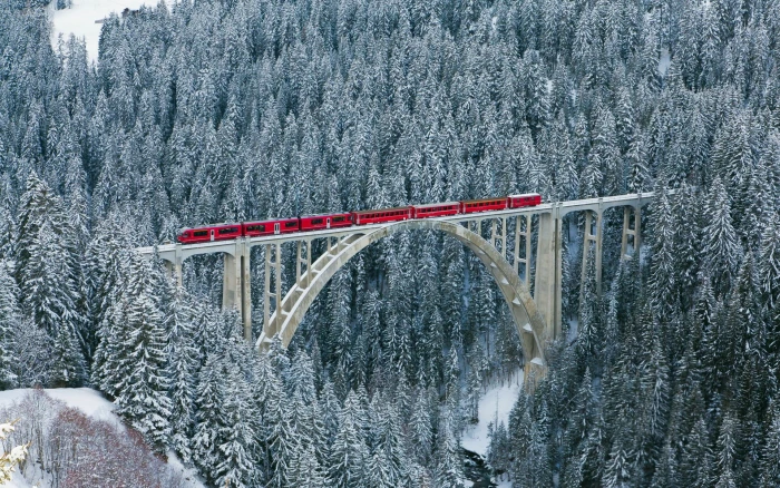 red train nature landscape winter bridge forest river Switzerland 2k
