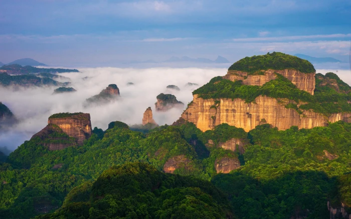 World Natural Heritage Danxia Mountain China scenery brown rocky cliff with tall green trees 2k