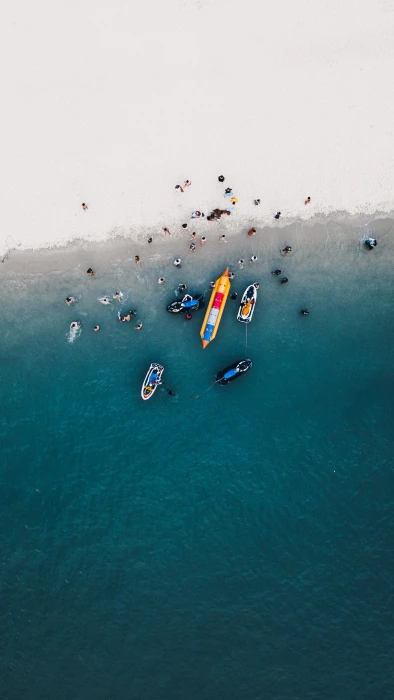 aerial photography of boats on seashore view with group people body water 2k