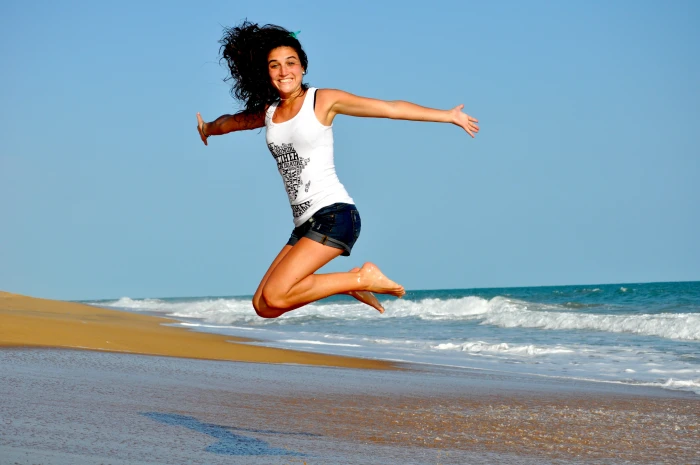 women s white and black floral dress woman wearing tank top jumping near seashore 2k 4k
