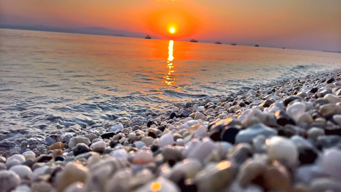 beach hanioti pebble greece sunset orange sky 2k 4k