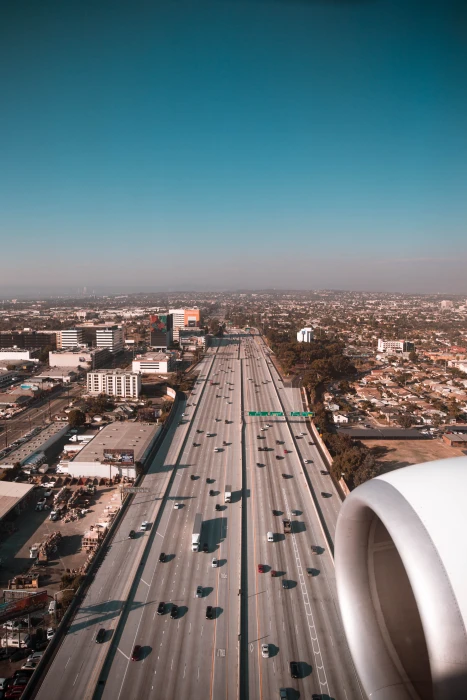 aerial view of cars on road plane engine highway city cityscape 2k 4k