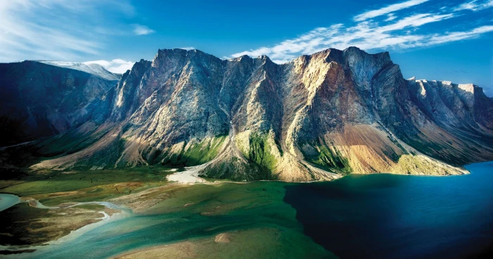 aerial view of mountain beside body water mountains clouds 2k 4k