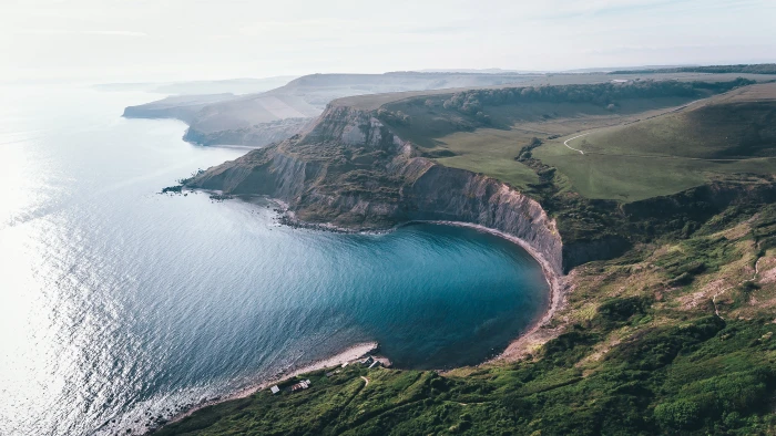 brown grass field cliff sea bay landscape water coast beauty in nature 2k 4k