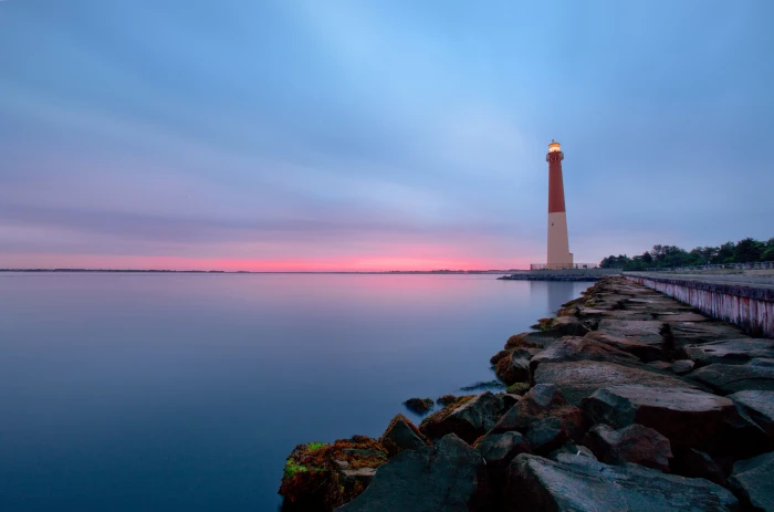 white and red lighthouse beside calm body of water Calm Before the Storm 2k 4k 5k
