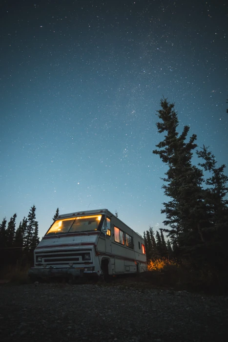 white and red RV beside trees van night sky camper star 2k 4k
